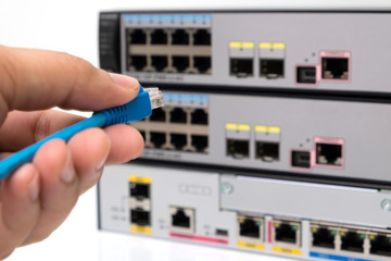 Hand holding ethernet cable