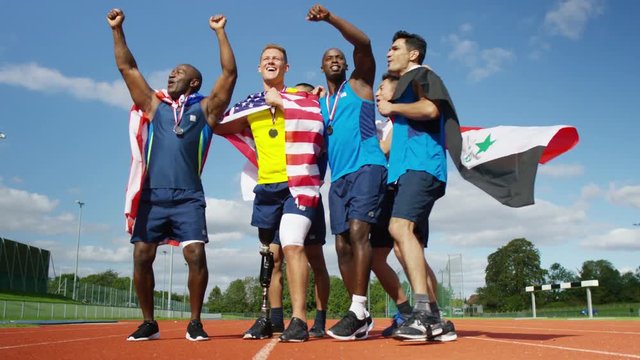  Group of athletes (disabled & able bodied) celebrate victory on running track