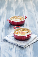 Fried eggs in red plates at wooden background