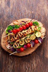 Roast Chicken filet kebab with cherry grilled on BBQ. tomatoes, zucchini and red onions on bamboo sticks