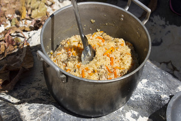 pilaf meat with vegetables in a large cast-iron pan
