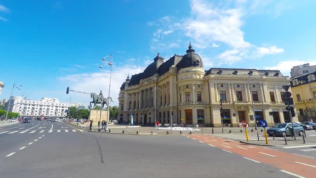 Pan left Time lapse of Central University Library and King Carol's statue in Bucharest