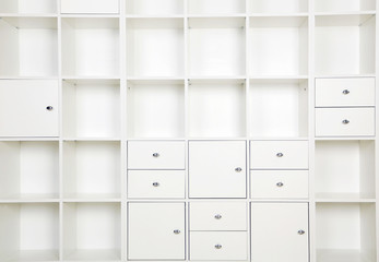 Empty shelves in white wooden rack, close up