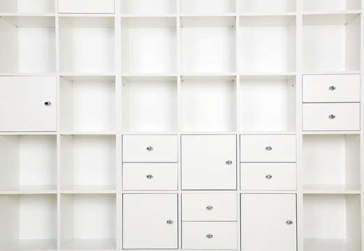 Empty shelves in white wooden rack, close up