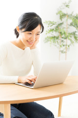 young asian woman using laptop