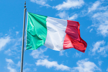 Fototapeta na wymiar Waving flag of Italy and blue sky 