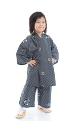 Happy asian boy in kimono sitting on white background