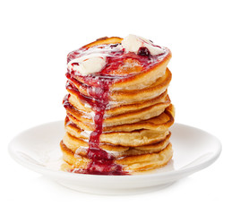Stack of delicious pancakes with butter and strawberry jam isolated on white.