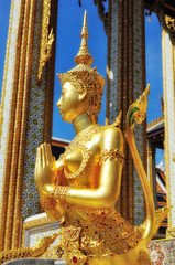 Sawasdee or hello in Thai Language. Close-up golden statue of Kinara at Wat Phra Kaew in Grand Place Complex in Bangkok, Thailand