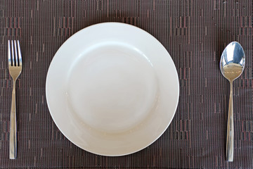 spoon fork and empty white plate