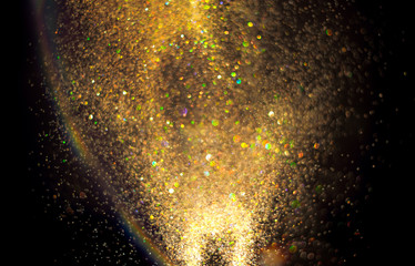 Fototapeta na wymiar Gold glitter texture on a black background
