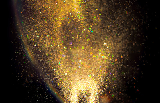Gold glitter texture on a black background
