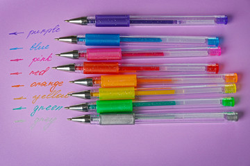 Fototapeta premium Set of colored pens on purple paper