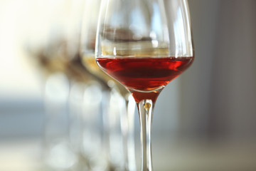 Many glasses of different wine in a row, close up