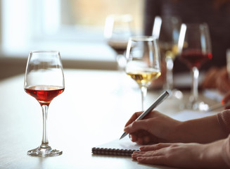 Experts tasting new sorts of wine at the table