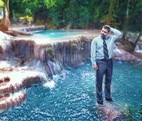 Businessman in the waterfall
