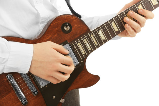 Young man playing electric guitar on white background