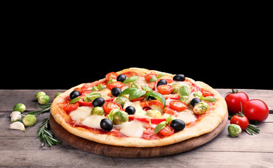 Delicious pizza with cheese and vegetables on black background