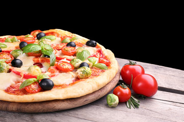 Delicious pizza with cheese and vegetables on black background