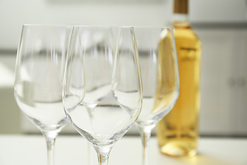 Wineglasses on blurred interior background