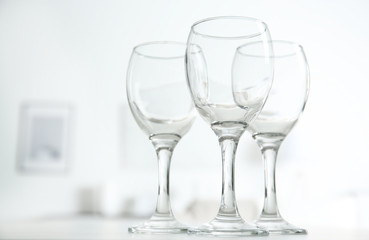 Wineglasses on blurred interior background
