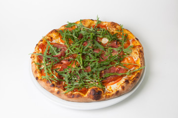 Pizza with meat and green arugula