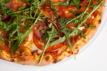 Pizza with meat and green arugula