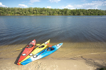 Fototapeta na wymiar Camping with kayaks on the beach on a sunny day.