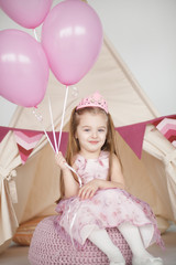 Birthday girl wearing a pink dress and crown