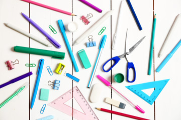 Flat lay of stationery on white wooden table background