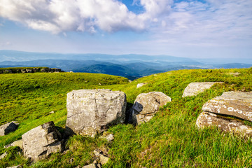 huge stones in valley on top of mountain range at sunrise