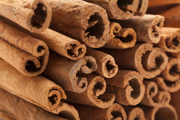 Raw Organic Cinnamon sticks (Cinnamomum verum).Macro closeup background texture. Front side view.