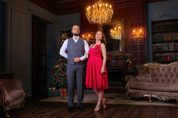 Beautiful well-dressed young couple standing on a steps in luxury interior - 110658793