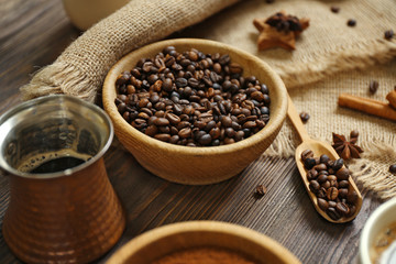 Coffee with beans and spices on wooden table closeup