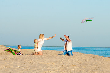 Happy family launching a kite.