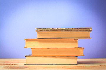 Vintage old books on wooden deck table