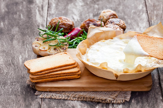 Delicious  baked camembert with roasted potato and toast