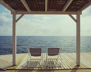 Summer holiday background with chairs over sea