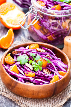 healthy  fresh salad with red cabbage and oranges with walnuts i