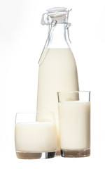 A bottle of rustic milk and two glasses  of milk