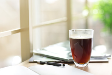 Cup of coffee and notebook on the table in cafe