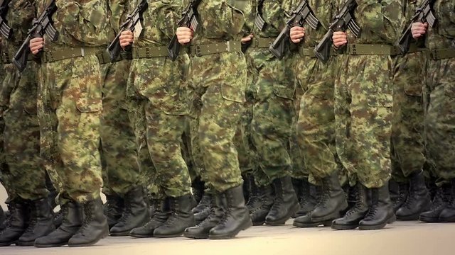 Soldiers marching in a parade through the town in slow motion, Slow Motion Video Clip