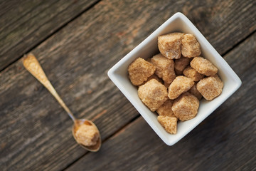 brown cane sugar on old wooden background