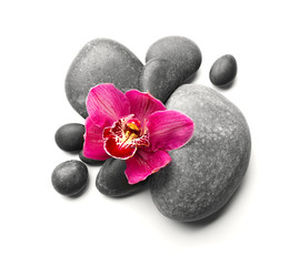 Obraz na płótnie Canvas Spa stones and red orchid isolated on white