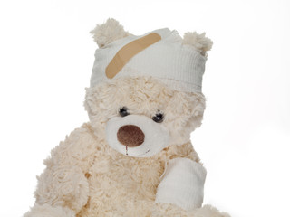 injured teddy bear with bandages.