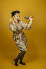 Portrait beautiful woman singing with hairbrush