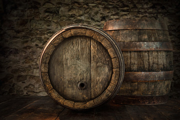Old oak barrels on blurred cellar wall