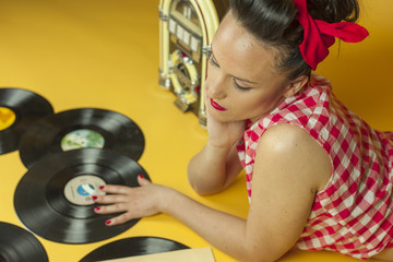 Close up portrait beautiful pin up girl with old vinil records