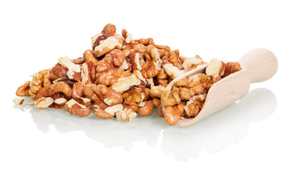 Bunch and a wooden scoop with shelled walnuts isolated on white background.
