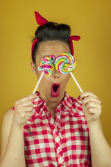 Close up portrait beautiful pin up girl with colorful lollipops